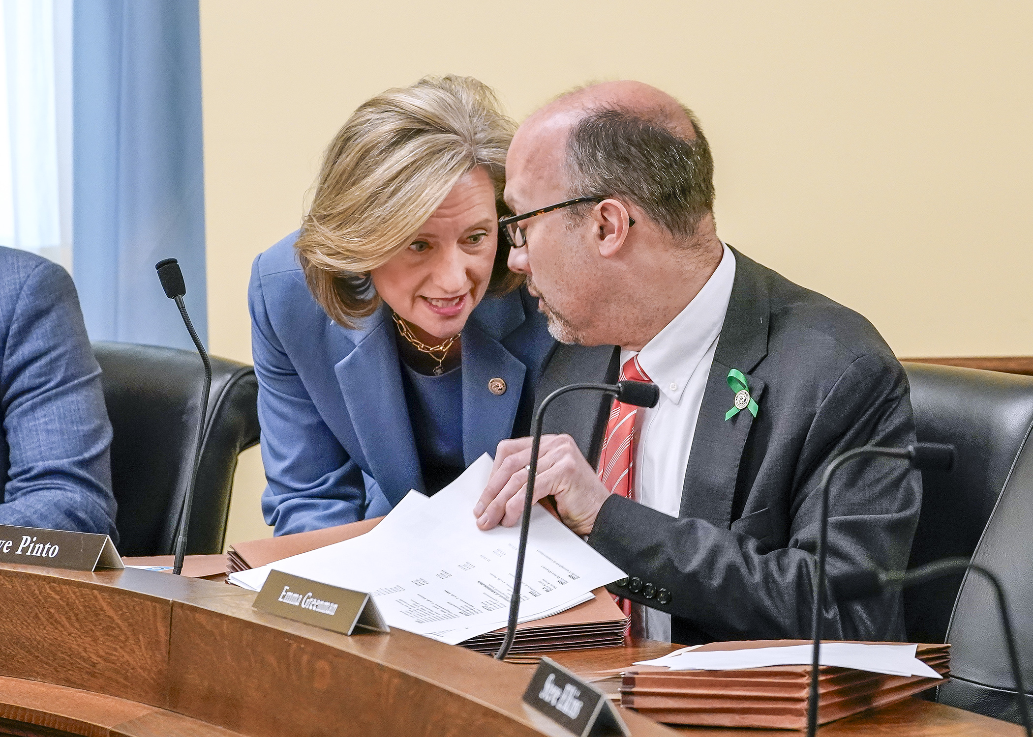 Rep. Kristin Robbins, chair, and Rep. Dave Pinto, DFL lead, confer before convening the House Fraud Prevention and State Agency Oversight Policy Committee for the final time May 5. (Photo by Andrew VonBank)
